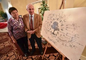 Leo Cognetti and Mary Petriello look over the Cognetti family tree during the family’s 50th annual Thanksgiving dinner at Genetti Manor in Dickson City. JASON FARMER STAFF PHOTOGRAPHER